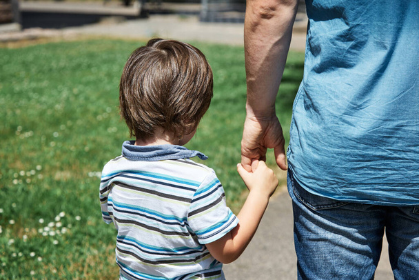 A photo of a boy with his guardian